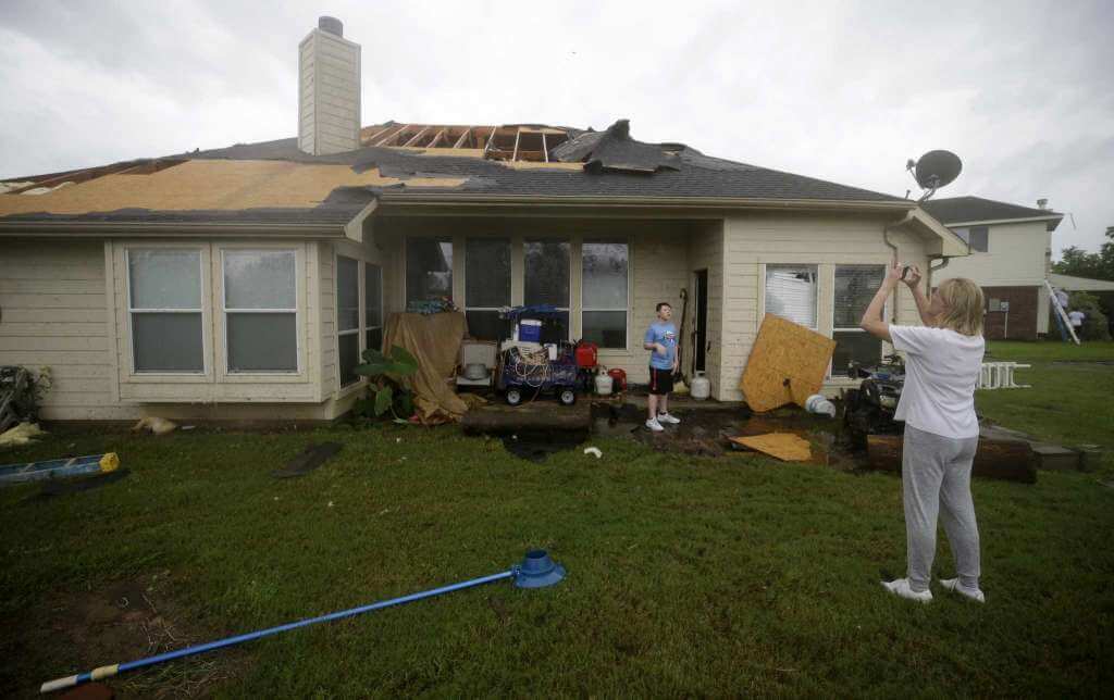 Shingles and plywood blown off the roof on a home in Houston TX by Hurricane Harvey
